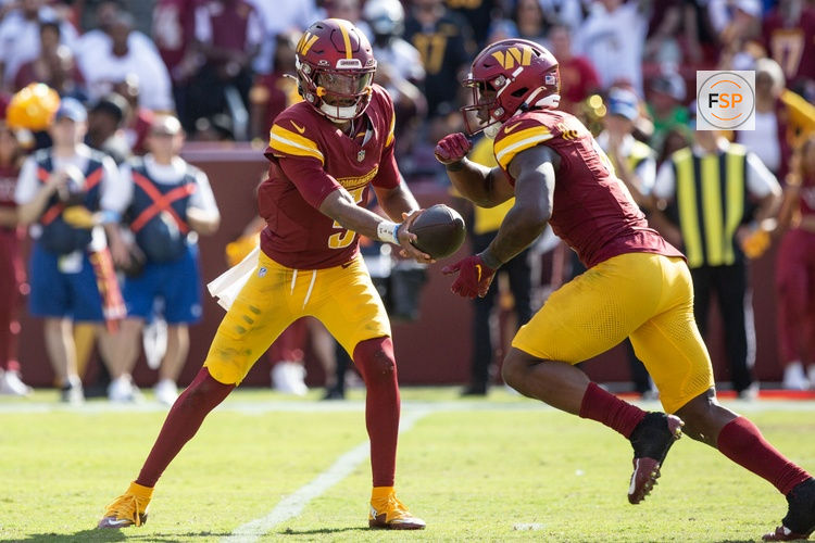 Sep 15, 2024; Landover, Maryland, USA; Washington Commanders quarterback Jayden Daniels (5) hand the ball off to running back Brian Robinson Jr. (8) in the second half against the New York Giants atCommanders Field. Credit: Luke Johnson-Imagn Images

