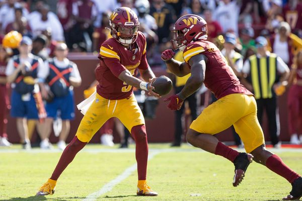 Sep 15, 2024; Landover, Maryland, USA; Washington Commanders quarterback Jayden Daniels (5) hand the ball off to running back Brian Robinson Jr. (8) in the second half against the New York Giants atCommanders Field. Mandatory Credit: Luke Johnson-Imagn Images

