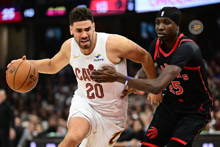 Nov 24, 2024; Cleveland, Ohio, USA; Cleveland Cavaliers forward Georges Niang (20) drives to the basket against Toronto Raptors forward Chris Boucher (25) during the first half at Rocket Mortgage FieldHouse. Credit: Ken Blaze-Imagn Images