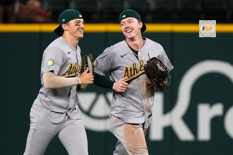 Sep 2, 2026; Arlington, Texas, USA;  Athletics left fielder Zack Gelof (20) and center fielder Henry Bolte (33) run off the field after defeating the Texas Rangers at Globe Life Field. Credit: Raymond Carlin III-Imagn Images