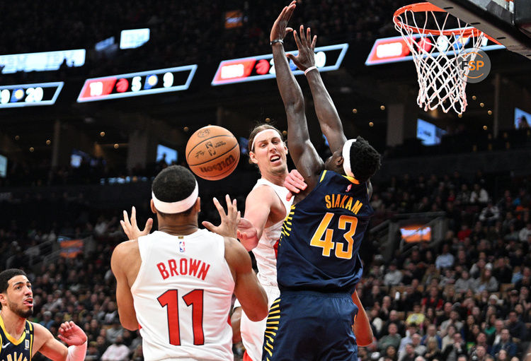 Apr 9, 2024; Toronto, Ontario, CAN;  Toronto Raptors forward Kelly Olynyk (41) passes the ball to guard Bruce Brown (11) as Indiana Pacers forward Pascal Siakam (423) defends in the second half at Scotiabank Arena. Credit: Dan Hamilton-USA TODAY Sports