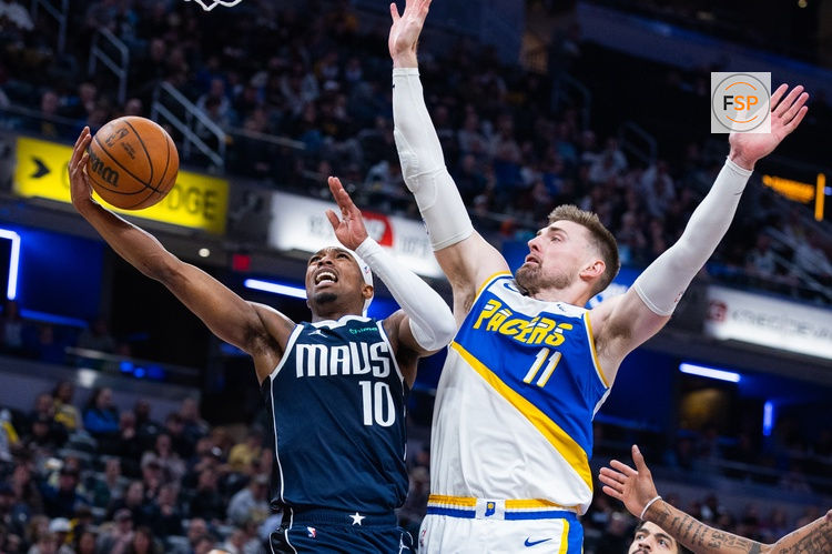 Feb 22, 2026; Indianapolis, Indiana, USA;  Dallas Mavericks guard Brandon Williams (10) shoots the ball while Indiana Pacers center Micah Potter (11) defends in the second half at Gainbridge Fieldhouse. Credit: Trevor Ruszkowski-Imagn Images