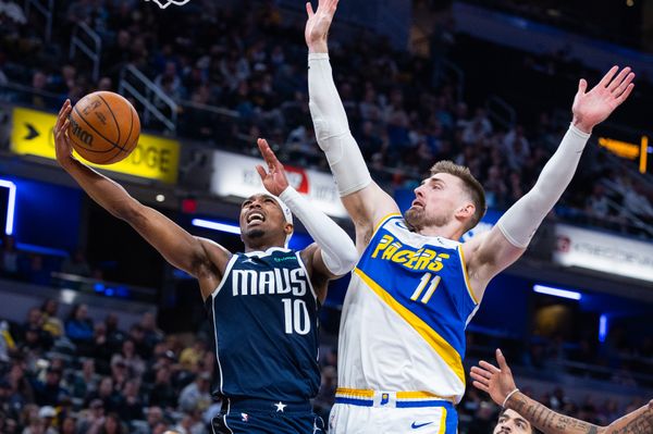 Feb 22, 2026; Indianapolis, Indiana, USA;  Dallas Mavericks guard Brandon Williams (10) shoots the ball while Indiana Pacers center Micah Potter (11) defends in the second half at Gainbridge Fieldhouse. Mandatory Credit: Trevor Ruszkowski-Imagn Images