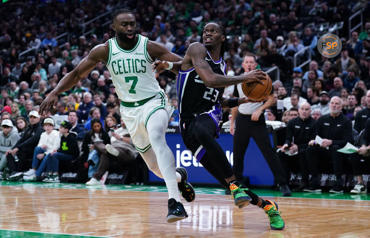 Jan 10, 2025; Boston, Massachusetts, USA; Sacramento Kings guard Keon Ellis (23) drives the ball against Boston Celtics guard Jaylen Brown (7) in the second quarter at TD Garden. Credit: David Butler II-Imagn Images