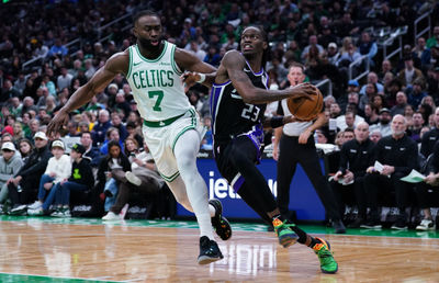 Jan 10, 2025; Boston, Massachusetts, USA; Sacramento Kings guard Keon Ellis (23) drives the ball against Boston Celtics guard Jaylen Brown (7) in the second quarter at TD Garden. Mandatory Credit: David Butler II-Imagn Images