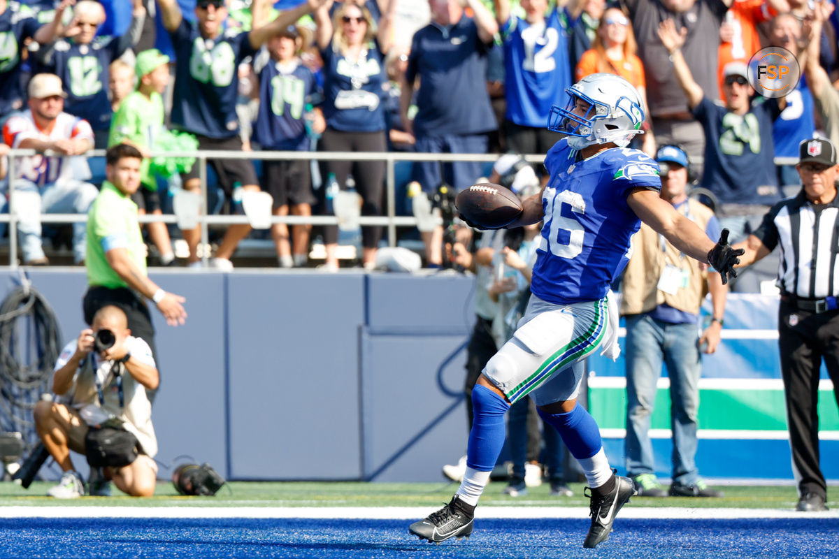 Sep 8, 2024; Seattle, Washington, USA; Seattle Seahawks running back Zach Charbonnet (26) celebrates after catching a touchdown pass against the Denver Broncos during the fourth quarter at Lumen Field. Credit: Joe Nicholson-Imagn Images