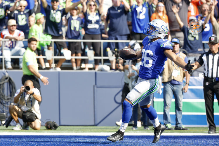 Sep 8, 2024; Seattle, Washington, USA; Seattle Seahawks running back Zach Charbonnet (26) celebrates after catching a touchdown pass against the Denver Broncos during the fourth quarter at Lumen Field. Credit: Joe Nicholson-Imagn Images