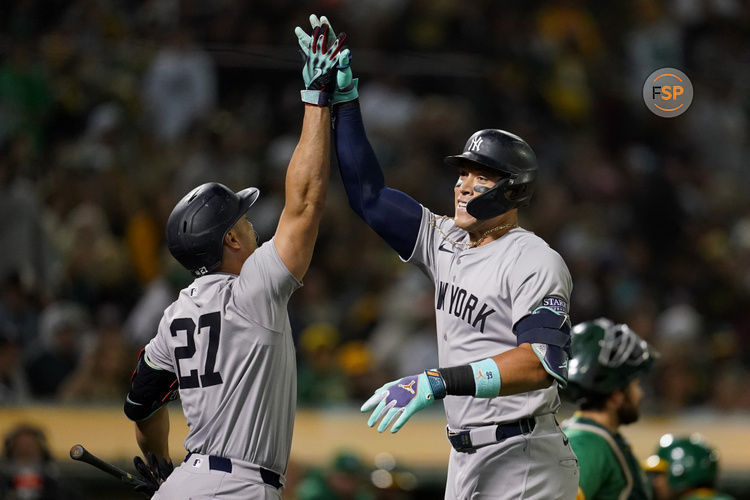 Sep 21, 2024; Oakland, California, USA; New York Yankees outfielder Aaron Judge (99) is congratulated by designated hitter Giancarlo Stanton (27) after hitting a home run against the Oakland Athletics in the seventh inning at the Oakland-Alameda County Coliseum. Credit: Cary Edmondson-Imagn Images