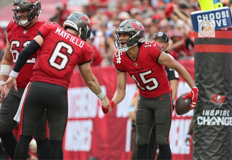 Dec 29, 2024; Tampa, Florida, USA; Tampa Bay Buccaneers wide receiver Jalen McMillan (15) is congratulated by quarterback Baker Mayfield (6) after he scored a touchdown  against the Carolina Panthers during the second quarter at Raymond James Stadium. Credit: Kim Klement Neitzel-Imagn Images