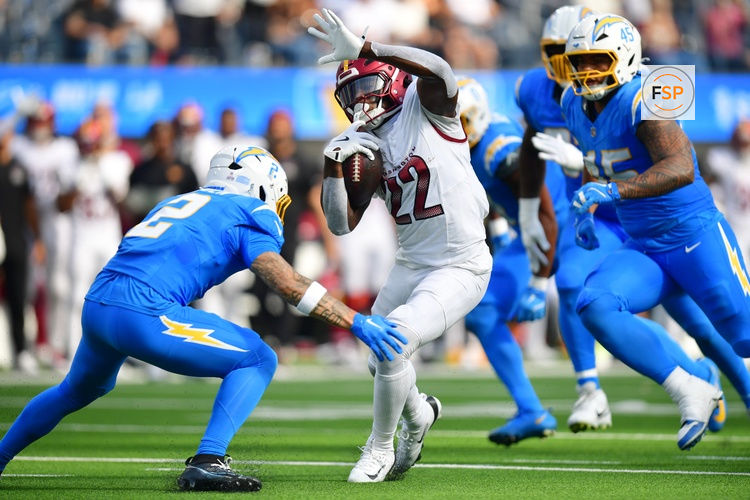 Oct 5, 2025; Inglewood, California, USA; Washington Commanders running back Jacory Croskey-Merritt (22) runs against Los Angeles Chargers cornerback Elijah Molden (2) in the second half at SoFi Stadium. Credit: Gary A. Vasquez-Imagn Images