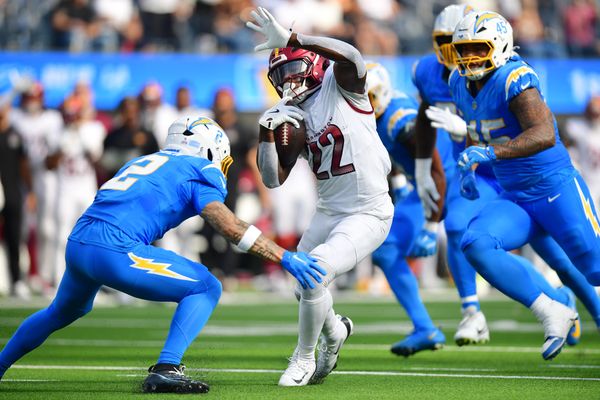Oct 5, 2025; Inglewood, California, USA; Washington Commanders running back Jacory Croskey-Merritt (22) runs against Los Angeles Chargers cornerback Elijah Molden (2) in the second half at SoFi Stadium. Mandatory Credit: Gary A. Vasquez-Imagn Images