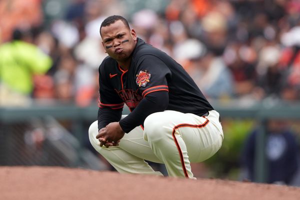 Apr 25, 2026; San Francisco, California, USA; San Francisco Giants first baseman Rafael Devers (16) kneels near first base after striking out against the Miami Marlins during the first inning at Oracle Park. Mandatory Credit: Darren Yamashita-Imagn Images