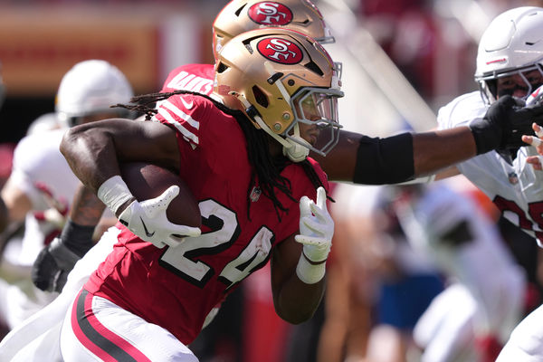 Oct 6, 2024; Santa Clara, California, USA; San Francisco 49ers running back Jordan Mason (24) carries the ball against the Arizona Cardinals during the second quarter at Levi's Stadium. Mandatory Credit: Darren Yamashita-Imagn Images