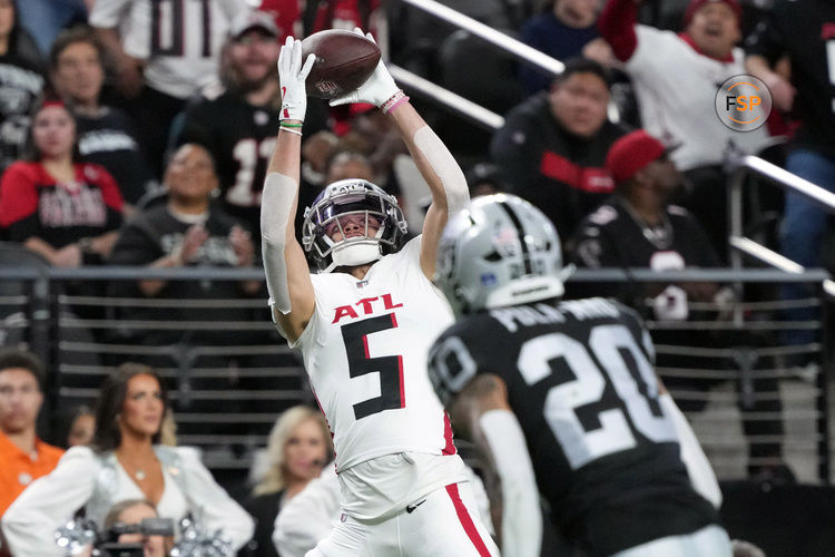 Dec 16, 2024; Paradise, Nevada, USA; Atlanta Falcons wide receiver Drake London (5) catches the ball against Las Vegas Raiders safety Isaiah Pola-Mao (20) in the first half at Allegiant Stadium. Credit: Kirby Lee-Imagn Images