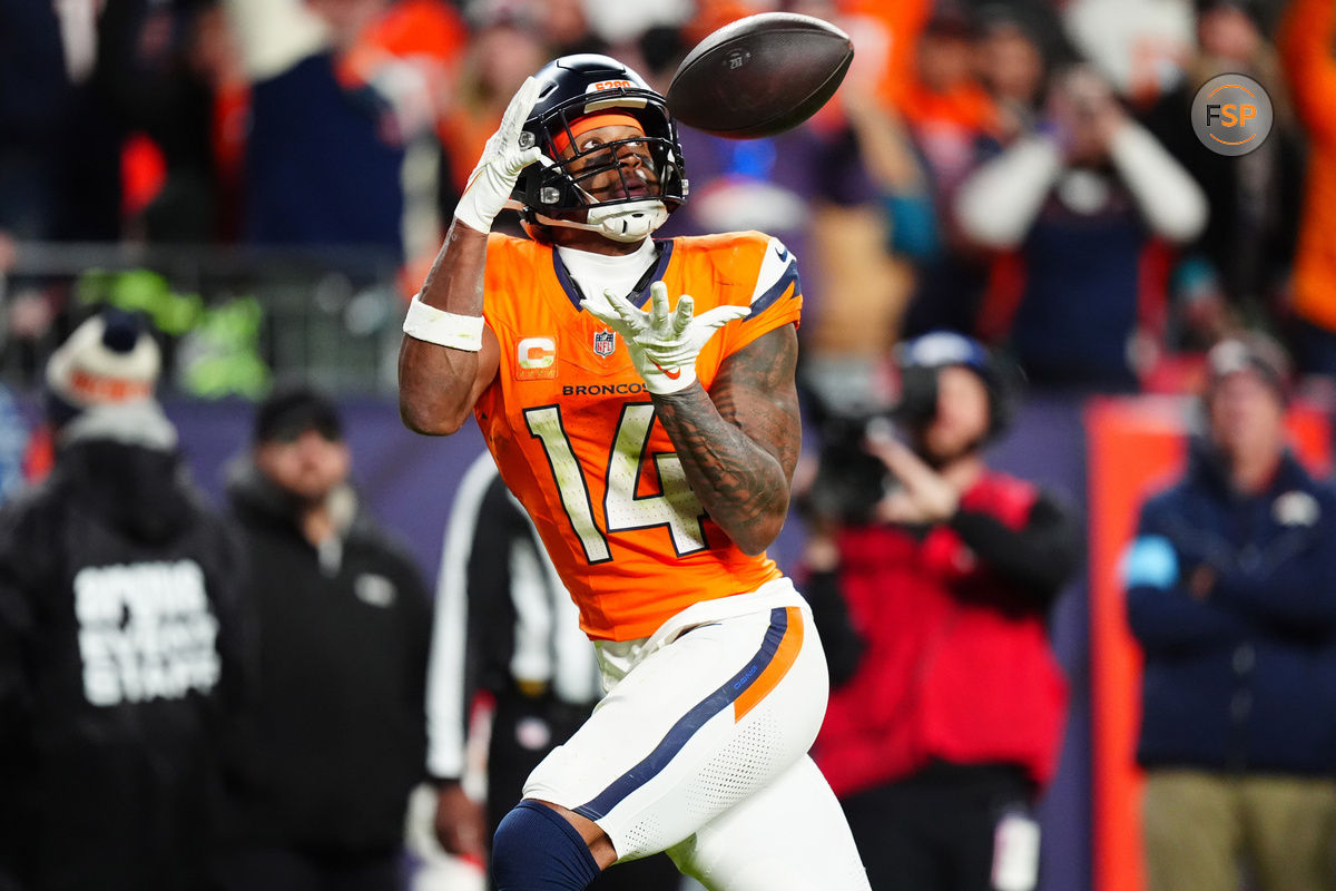 Dec 15, 2024; Denver, Colorado, USA; Denver Broncos wide receiver Courtland Sutton (14) prepares to pull in a touchdown reception in the fourth quarter against the Indianapolis Colts at Empower Field at Mile High. Credit: Ron Chenoy-Imagn Images