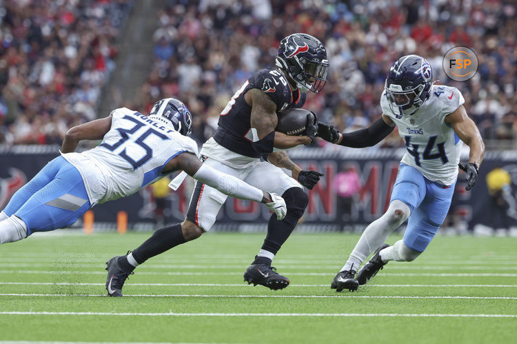 Nov 24, 2024; Houston, Texas, USA; Houston Texans running back Joe Mixon (28) runs with the ball as Tennessee Titans cornerback Daryl Worley (35) attempts to make a tackle during the fourth quarter at NRG Stadium. Credit: Troy Taormina-Imagn Images