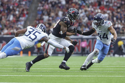 Nov 24, 2024; Houston, Texas, USA; Houston Texans running back Joe Mixon (28) runs with the ball as Tennessee Titans cornerback Daryl Worley (35) attempts to make a tackle during the fourth quarter at NRG Stadium. Mandatory Credit: Troy Taormina-Imagn Images