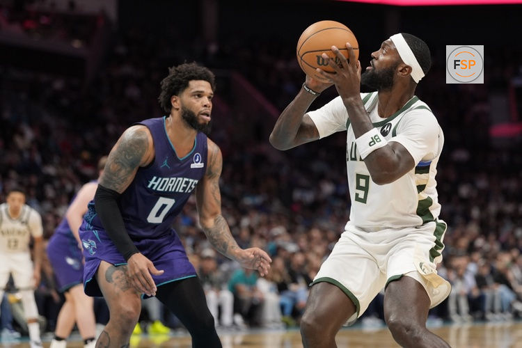 Nov 12, 2025; Charlotte, North Carolina, USA; Milwaukee Bucks forward Bobby Portis (9) shoots the ball defended by Charlotte Hornets forward Miles Bridges (0) during the second half at Spectrum Center. Credit: Jim Dedmon-Imagn Images