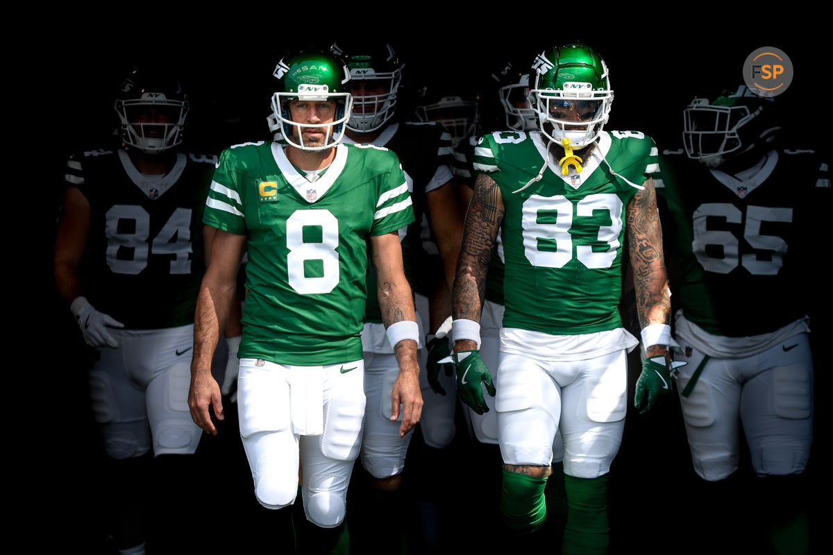 Sep 15, 2024; Nashville, Tennessee, USA;  New York Jets quarterback Aaron Rodgers (8) and tight end Tyler Conklin (83) takes the field against the Tennessee Titans during the first half at Nissan Stadium. Credit: Steve Roberts-Imagn Images