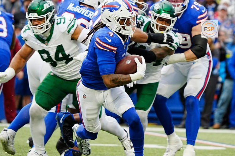 Buffalo Bills running back James Cook (4) finds an opening and runs with the ball for a gain of about six yards during first half action at the Bills home game against the New York Jets at Highmark Stadium in Orchard Park on Dec. 29, 2024.