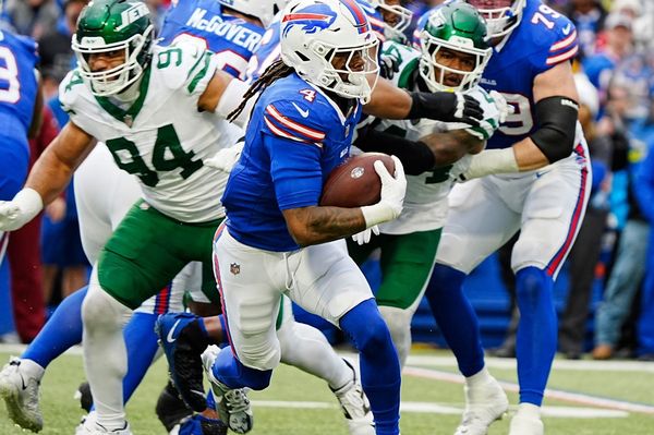Buffalo Bills running back James Cook (4) finds an opening and runs with the ball for a gain of about six yards during first half action at the Bills home game against the New York Jets at Highmark Stadium in Orchard Park on Dec. 29, 2024.