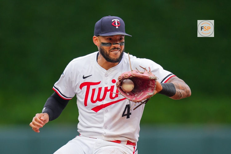 Jun 25, 2025; Minneapolis, Minnesota, USA; Minnesota Twins shortstop Carlos Correa (4) fields a ground ball against the Seattle Mariners in the second inning at Target Field. Credit: Brad Rempel-Imagn Images