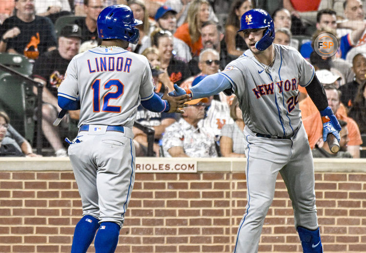 BALTIMORE, MD - August 5: New York Mets shortstop Francisco Lindor (12) is congratulated by first baseman Pete Alonso (20) after scoring during the New York Mets versus the Baltimore Orioles on August 5, 2023 at Oriole Park at Camden Yards in Baltimore, MD.  (Photo by Mark Goldman/Icon Sportswire)