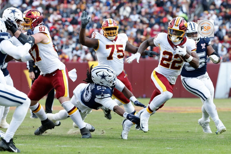 Dec 25, 2025; Landover, Maryland, USA; Washington Commanders running back Jacory Croskey-Merritt (22) carries the ball defended by Dallas Cowboys defensive end James Houston (53) in the third quarter at Northwest Stadium. Credit: Amber Searls-Imagn Images