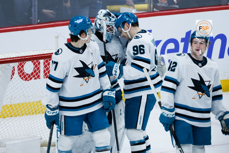 Apr 16, 2026; Winnipeg, Manitoba, CAN;  San Jose Sharks goalie Alex Nedeljkovic (33) is congratulated by his team mates on his win against the Winnipeg Jets at the end of the third period at Canada Life Centre. Credit: Terrence Lee-Imagn Images