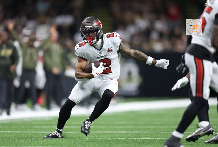 Oct 26, 2025; New Orleans, Louisiana, USA; Tampa Bay Buccaneers wide receiver Emeka Egbuka (2) runs for a gain during the first quarter against the New Orleans Saints at Caesars Superdome. Credit: Stephen Lew-Imagn Images