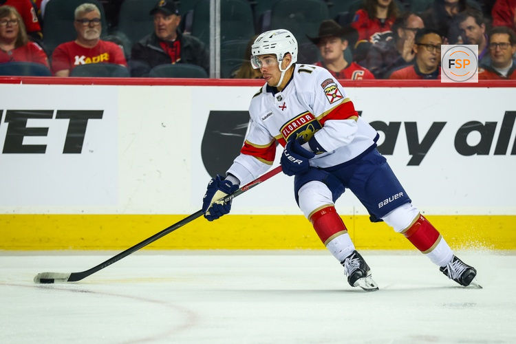 Mar 20, 2026; Calgary, Alberta, CAN; Florida Panthers center Evan Rodrigues (17) skates with the puck against the Calgary Flames during the first period at Scotiabank Saddledome. Credit: Sergei Belski-Imagn Images