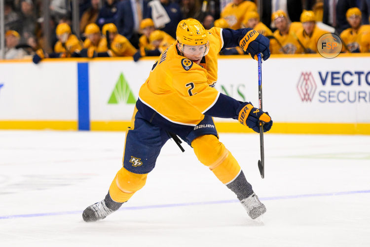 Jan 21, 2025; Nashville, Tennessee, USA;  Nashville Predators defenseman Luke Schenn (2) takes a shot on goal against the San Jose Sharks during the first period at Bridgestone Arena. Credit: Steve Roberts-Imagn Images