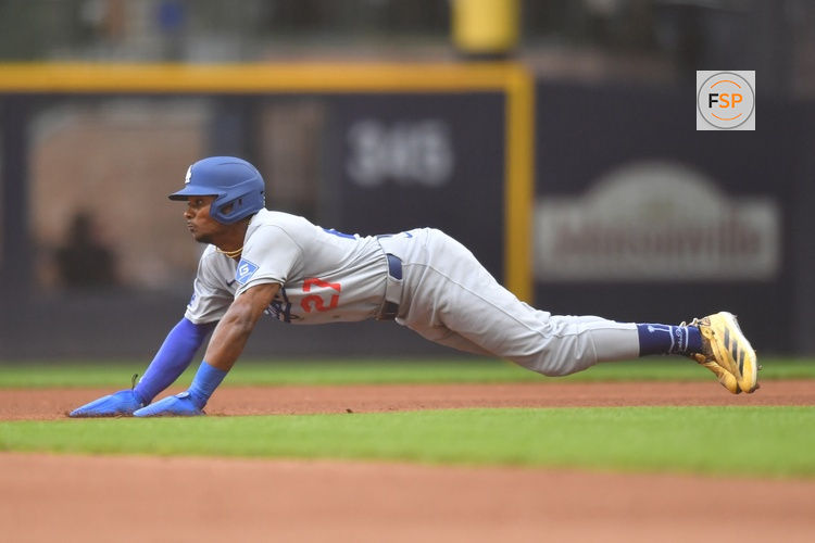 Jul 9, 2025; Milwaukee, Wisconsin, USA; Los Angeles Dodgers left fielder Esteury Ruiz (27) slides to steal second base during the fifth inning against the Milwaukee Brewers at American Family Field. Credit: Patrick Gorski-Imagn Images