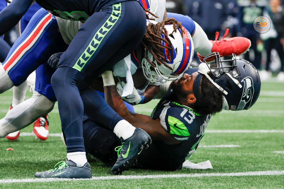 Oct 27, 2024; Seattle, Washington, USA; Buffalo Bills running back James Cook (4) rushes for a touchdown against Seattle Seahawks linebacker Ernest Jones IV (13) during the fourth quarter at Lumen Field. Credit: Joe Nicholson-Imagn Images