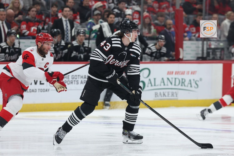 Jan 17, 2026; Newark, New Jersey, USA; New Jersey Devils defenseman Luke Hughes (43) looks to move the puck against the Carolina Hurricanes during the first period at Prudential Center. Credit: Thomas Salus-Imagn Images
