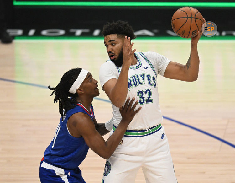 LOS ANGELES, CA - FEBRUARY 12: Los Angeles Clippers Guard Terance Mann (14) guards Minnesota Timberwolves Forward Karl-Anthony Towns (32) during a NBA basketball game on February 12, 2024. at the Crypto.com Arena in Los Angeles, CA.(Photo by John McCoy/Icon Sportswire)