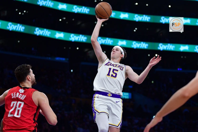 Dec 25, 2025; Los Angeles, California, USA; Los Angeles Lakers guard Austin Reaves (15) shoots against Houston Rockets center Alperen Sengun (28) during the first half at Crypto.com Arena. Credit: Gary A. Vasquez-Imagn Images
