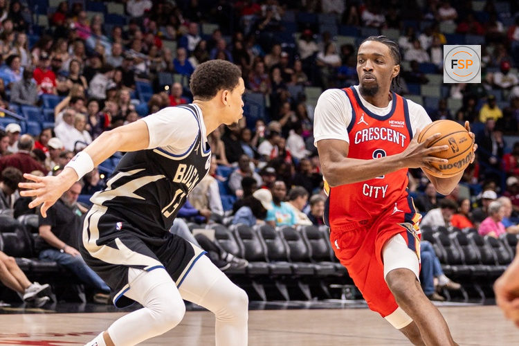 Feb 20, 2026; New Orleans, Louisiana, USA;  New Orleans Pelicans forward Herbert Jones (2) dribbles against Milwaukee Bucks guard Ryan Rollins (13) during the second half at Smoothie King Center. Credit: Stephen Lew-Imagn Images
