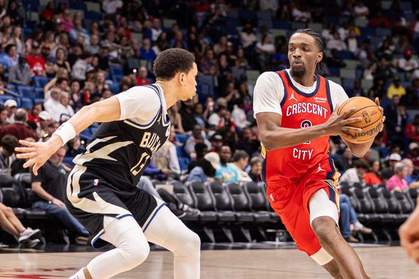 Feb 20, 2026; New Orleans, Louisiana, USA;  New Orleans Pelicans forward Herbert Jones (2) dribbles against Milwaukee Bucks guard Ryan Rollins (13) during the second half at Smoothie King Center. Mandatory Credit: Stephen Lew-Imagn Images