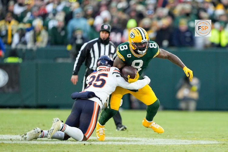 Dec 7, 2025; Green Bay, Wisconsin, USA; Green Bay Packers running back Josh Jacobs (8) is tackled by Chicago Bears defensive back C.J. Gardner-Johnson (35) in the first quarter at Lambeau Field. Credit: Jeff Hanisch-Imagn Images