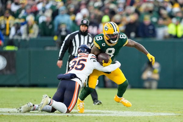 Dec 7, 2025; Green Bay, Wisconsin, USA; Green Bay Packers running back Josh Jacobs (8) is tackled by Chicago Bears defensive back C.J. Gardner-Johnson (35) in the first quarter at Lambeau Field. Mandatory Credit: Jeff Hanisch-Imagn Images