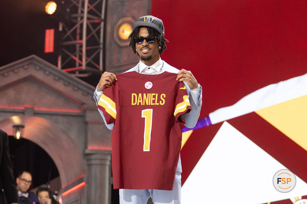 DETROIT, MI - APRIL 25: Washington Commanders Quarterback Jayden Daniels poses with a jersey after being picked second overall during day 1 of the NFL Draft on April 25, 2024 at Campus Martius Park and Hart Plaza in Detroit, MI. (Photo by John Smolek/Icon Sportswire)