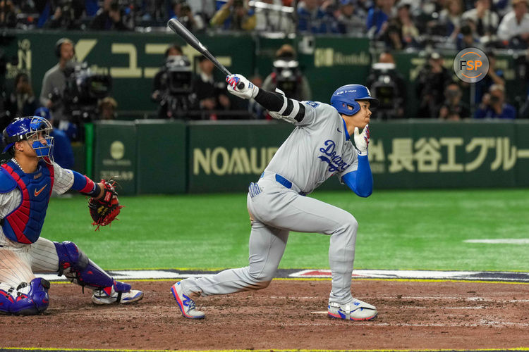 Mar 18, 2025; Bunkyo, Tokyo, JPN; Los Angeles Dodgers designated hitter Shohei Ohtani (17) hits a double against the Chicago Cubs in the ninth inning during the Tokyo Series at Tokyo Dome. Credit: Darren Yamashita-Imagn Images