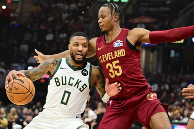 Nov 4, 2024; Cleveland, Ohio, USA; Milwaukee Bucks guard Damian Lillard (0) drives to the basket against Cleveland Cavaliers forward Isaac Okoro (35) during the first quarter at Rocket Mortgage FieldHouse. Mandatory Credit: Ken Blaze-Imagn Images