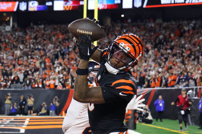Dec 28, 2024; Cincinnati, Ohio, USA;  Cincinnati Bengals  wide receiver Tee Higgins (5) catches a touchdown as Denver Broncos cornerback Riley Moss (21) defends during the fourth quarter at Paycor Stadium. Mandatory Credit: Joseph Maiorana-Imagn Images