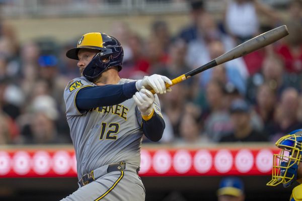 Jun 20, 2025; Minneapolis, Minnesota, USA; Milwaukee Brewers first baseman Rhys Hoskins (12) hits a single against the Minnesota Twins in the fifth inning at Target Field. Mandatory Credit: Jesse Johnson-Imagn Images