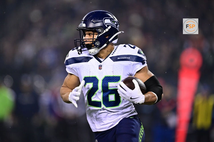 Dec 26, 2024; Chicago, Illinois, USA; Seattle Seahawks running back Zach Charbonnet (26) runs the ball against the Chicago Bears during the first quarter at Soldier Field. Credit: Daniel Bartel-Imagn Images
