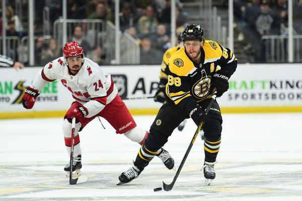 Apr 5, 2025; Boston, Massachusetts, USA; Boston Bruins right wing David Pastrnak (88) skates the puck ahead of Carolina Hurricanes center Seth Jarvis (24) during the first period at TD Garden. Mandatory Credit: Bob DeChiara-Imagn Images