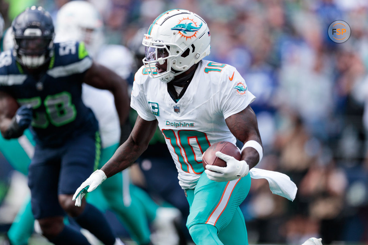 Sep 22, 2024; Seattle, Washington, USA; Miami Dolphins wide receiver Tyreek Hill (10) runs with the ball during the third quarter against Seattle Seahawks at Lumen Field. Credit: Kevin Ng-Imagn Images