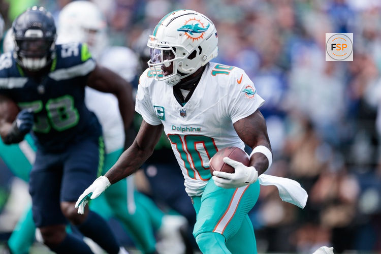 Sep 22, 2024; Seattle, Washington, USA; Miami Dolphins wide receiver Tyreek Hill (10) runs with the ball during the third quarter against Seattle Seahawks at Lumen Field. Credit: Kevin Ng-Imagn Images